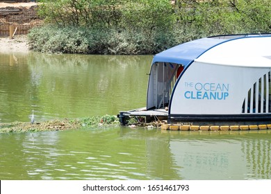 "Klang, Malaysia- Circa February, 2020: The Ocean Cleanup interceptor for rubbish extraction at Klang River with rubbish and bird insight."