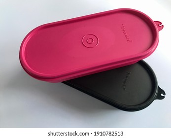 KLANG, MALAYSIA - February 6, 2021 : Top View Of Tupperware Brand Lid Containers Isolated On Gray Background