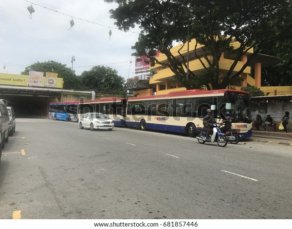 Klang, Malaysia - July\
20th, 2017. Busy road and people are waiting for bus at Klang city\
bus station