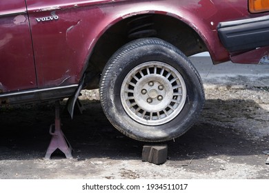 Klang Selangor, Malaysia - March 12,2021 : Old Wreck Volvo On A Car Jack Stand With Damaged Goodyear Tyre