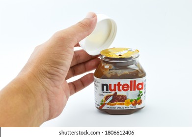 Klang,Malaysia: 1st September 2020- Man Hand Open Up Of Nutella Hazelnut Cover Spread Jar On White Background Including Clipping Path. Nutella Is A Brand Of Sweetened Hazelnut Cocoa Spread. 