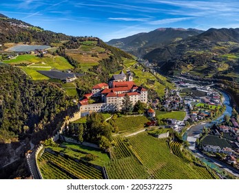 Klausen, Italy - Aerial view of the Säben Abbey (Monastero di Sabiona) with Chiusa (Klausen) comune northeast of the city of Bolzano and South Tyrol Dolomites at background on a sunny summer day 