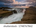 Klayar Beach when colorful sunset with silky water falls down and big waves.