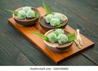Klepon is a traditional rice cake ball filled with molten palm sugar and coated in grated coconut from Java, Indonesia. - Shutterstock ID 2181530603