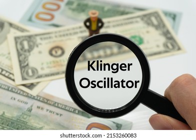 Klinger Oscillator.Magnifying glass showing the words.Background of banknotes and coins.basic concepts of finance.Business theme.Financial terms.