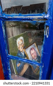 Klintholm, Denmark Oct 4, 2022 Painted Portraits Of Older Men Seen In The Window Of A Small Art Studio.