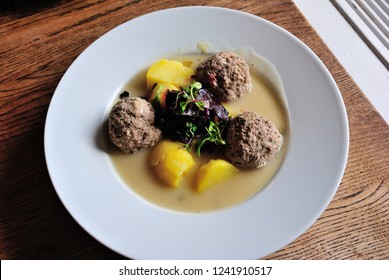 Königsberger Klopse -  Prussian Specialty Of Meatballs In A White Sauce, Served With Capers, Anchovy, Young Potatoes And Beetroot In Leipzig, Germany