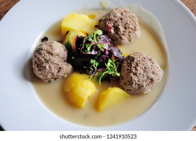 Königsberger Klopse -  Prussian Specialty Of Meatballs In A White Sauce, Served With Capers, Anchovy, Young Potatoes And Beetroot In Leipzig, Germany