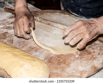 Kneading The Sweet Pizza Manually Is Italian Peasant Tradition With Ancient And Healthy Method, With The Hands Of An Old Lady On The Rough Wooden Table In The Kitchen