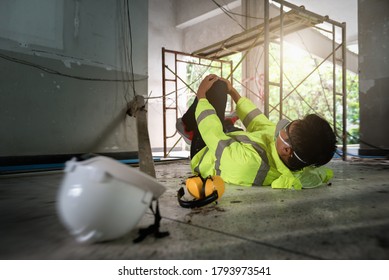 Knee accident at work of construction worker at site. Builder accident falls scaffolding on floor, Electric shock, Unsafe in work concept. Add zoom filter effect for feelings.