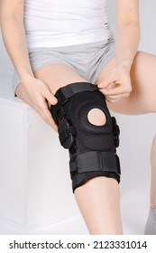 Knee Support Brace On Leg Isolated On White Background. Elastic Orthopedic Orthosis. Anatomic Braces For Knee Fixation, Injuries And Pain. Protective Knee Joint Bandage Sleeve. Trauma, Rehabilitation.