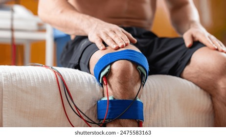 Knee therapy session using electrotherapy for rehabilitation and pain relief. - Powered by Shutterstock