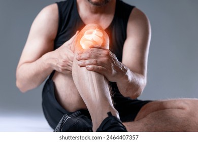 Knee trauma and joint pain of a male athlete during sporting activity with x-ray image. Ankle pain in detail - Sports injuries concept - Powered by Shutterstock