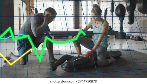 Kneeling coach coaching trainee doing CPR on mannequin, gym with data overlay, red wraps. Instructor, lifesaving, firstaid, training, teamwork, fitness, windows