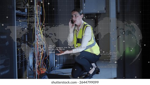 Kneeling technician holding smartphone troubleshooting cables in server room, with digital overlays. Technology, infrastructure, connectivity, electronics, industrial, cybersecurity, digital