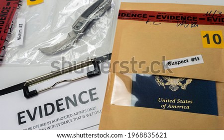Knife and american passport in crime lab test ball, conceptual image