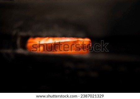 A knife being forged in a forge