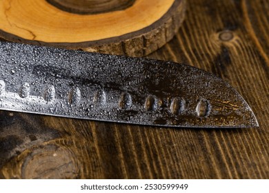 knife covered with water droplets , a wet blade of a sharp knife with a wide blade, close up - Powered by Shutterstock