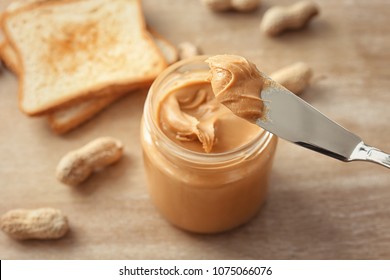 Knife with creamy peanut butter, closeup
