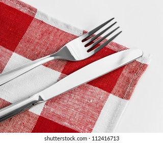 Knife And Fork On Red Checked Tablecloth