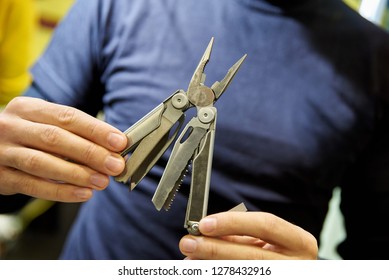 Knife Multitool Turned Into Pliers In The Hands Of A Man
