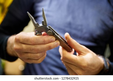 Knife Multitool Turned Into Pliers In The Hands Of A Man
