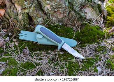 Knife and plastic sheath. Scandinavian knife on green moss. Sharp tourist knife. Knife with an emphasis. Daylight. - Shutterstock ID 1967236894