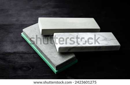Knife Sharpening Stone Set For Kitchen Knives Lies On Dark Table