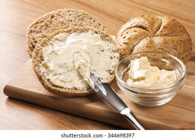 A Knife Spreading Butter On Bread