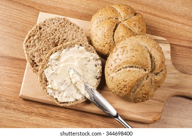 A Knife Spreading Butter On Bread