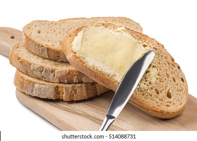 A Knife Spreading Butter On Bread