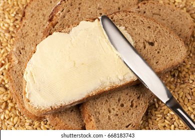 A Knife Spreading Butter On Bread