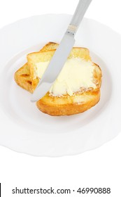 Knife Spreading Butter On Toast In White Plate