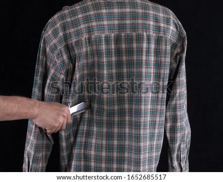 the knife is stuck in the back