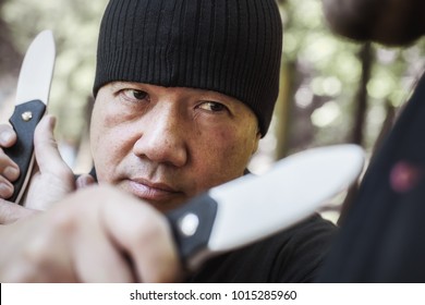 Knife Vs Knife Fight. Filipino Martial Arts Instructor Demonstrates Self Defense Disarming Technique Against Threat And Knife Attack