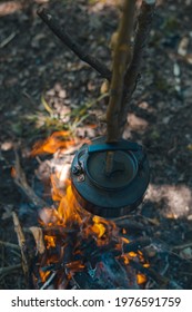 With Knife, Water Bottle And Titanium Mug Near The Fire Outdoors. Bushcraft, Adventure, Travel, Tourism And Camping Concept.