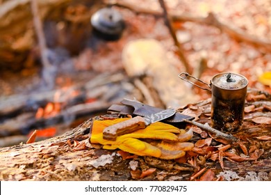 With Knife, Water Bottle And Titanium Mug Near The Fire Outdoors. Bushcraft, Adventure, Travel, Tourism And Camping Concept.