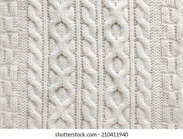 Knit texture of light natural wool knitted fabric with cable pattern as background