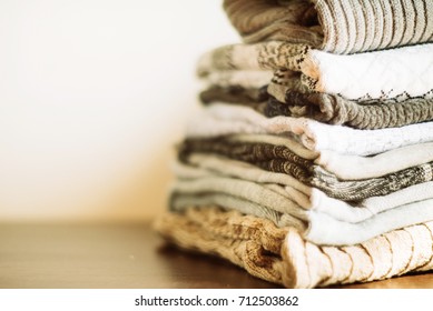 knit warm clothes neatly folded on the labels, texts, copyspace