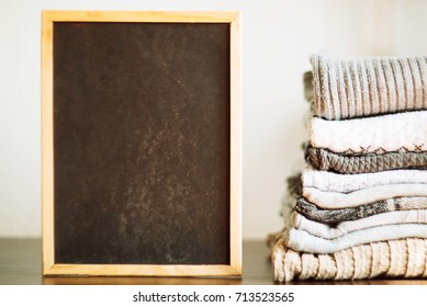 knit warm clothes neatly folded on the labels, texts, copyspace