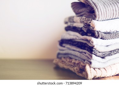 knit warm clothes neatly folded on the labels, texts, copyspace