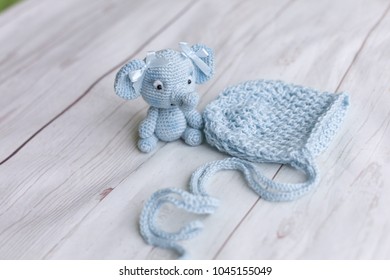 Knitted Baby Hat And Thai Elephant. Beanie For Newborn Baby. The Cap Is Blue. Knitted Toy