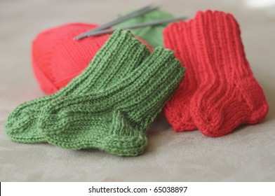 Knitted Baby Socks In Red And Green