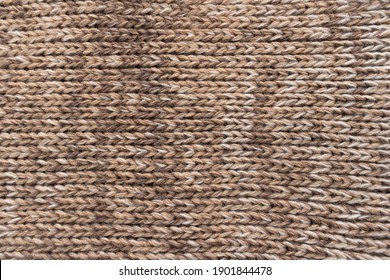 Knitted Background. Knitted Wallpaper. Beige Knitted Fabric. Knitted Texture. Soft Material. Brown, Beige And White Handmade Sweater Close Up Photo. Cozy Background. Knitwear Detail. Woolen Cloth.