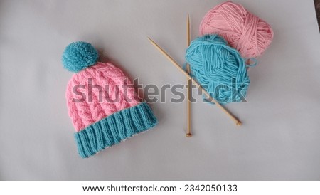 Knitted beanie made out of pink and blue milk cotton yarn