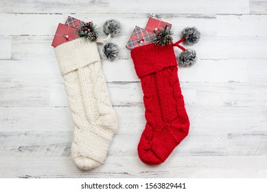 Knitted Christmas Stockings On White Wooden Background - Holiday Gift Giving