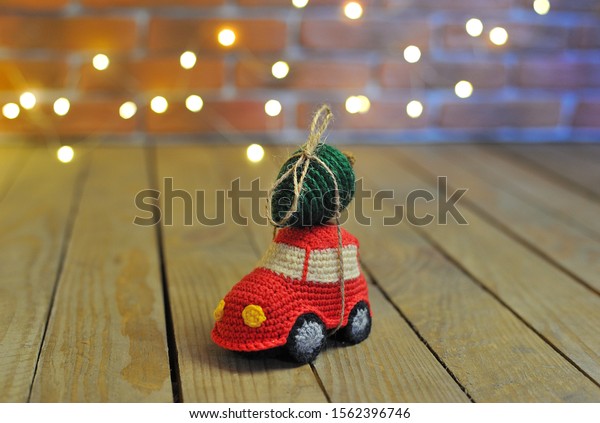 knitted christmas toys. small car with christmas\
tree on the roof