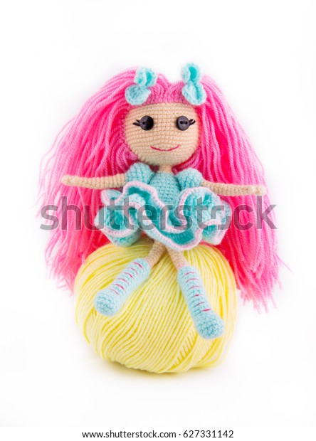 doll with pink hair and button eyes