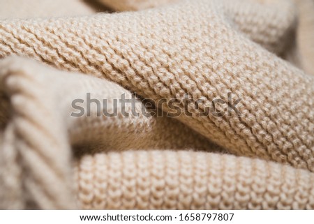 Knitted fabric wool texture close up as a background. Abstract backdrop.
