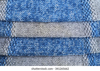 Knitted gray and blue wool pattern close up.